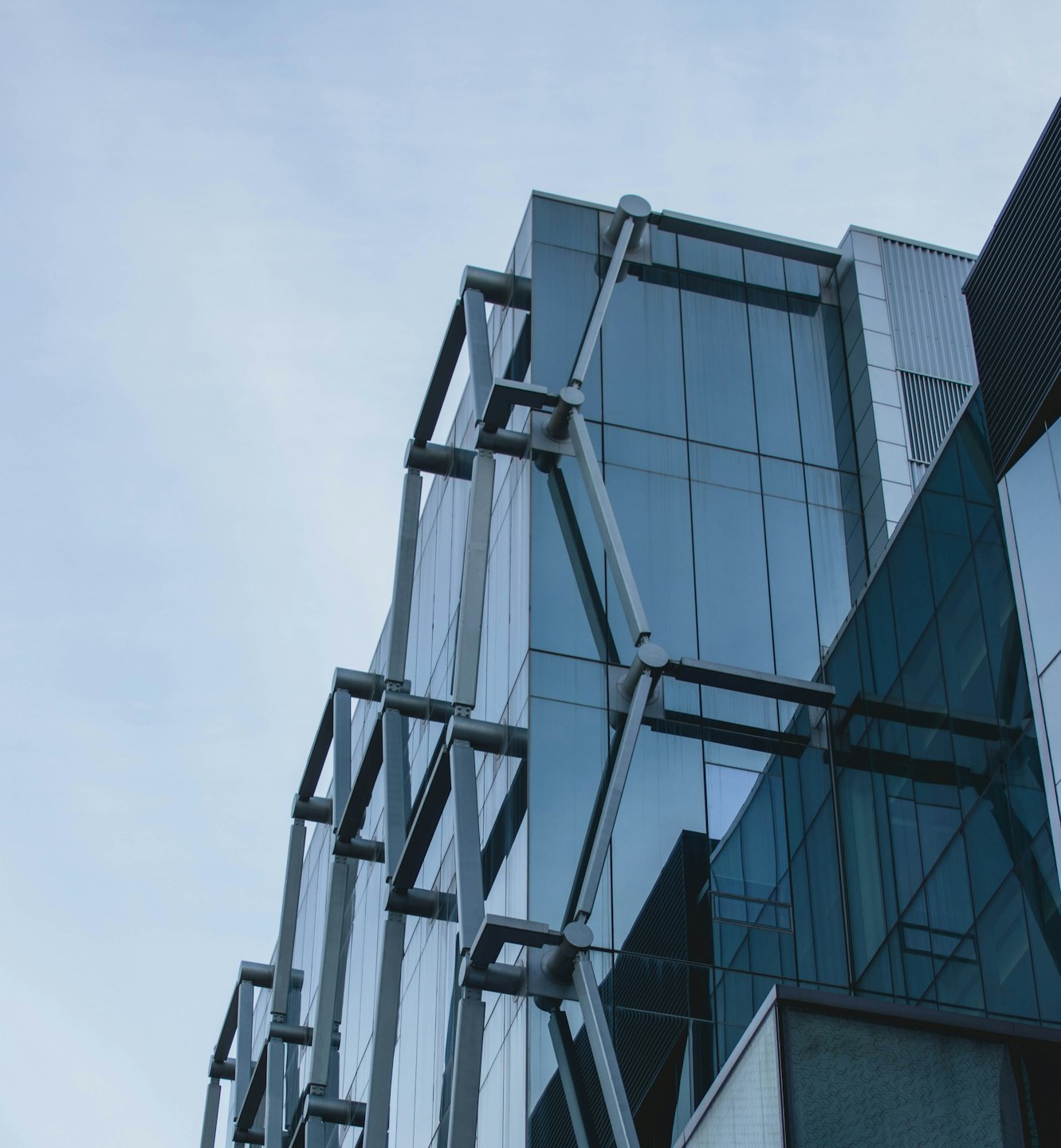 Modern office building with glass facade and metal framework.