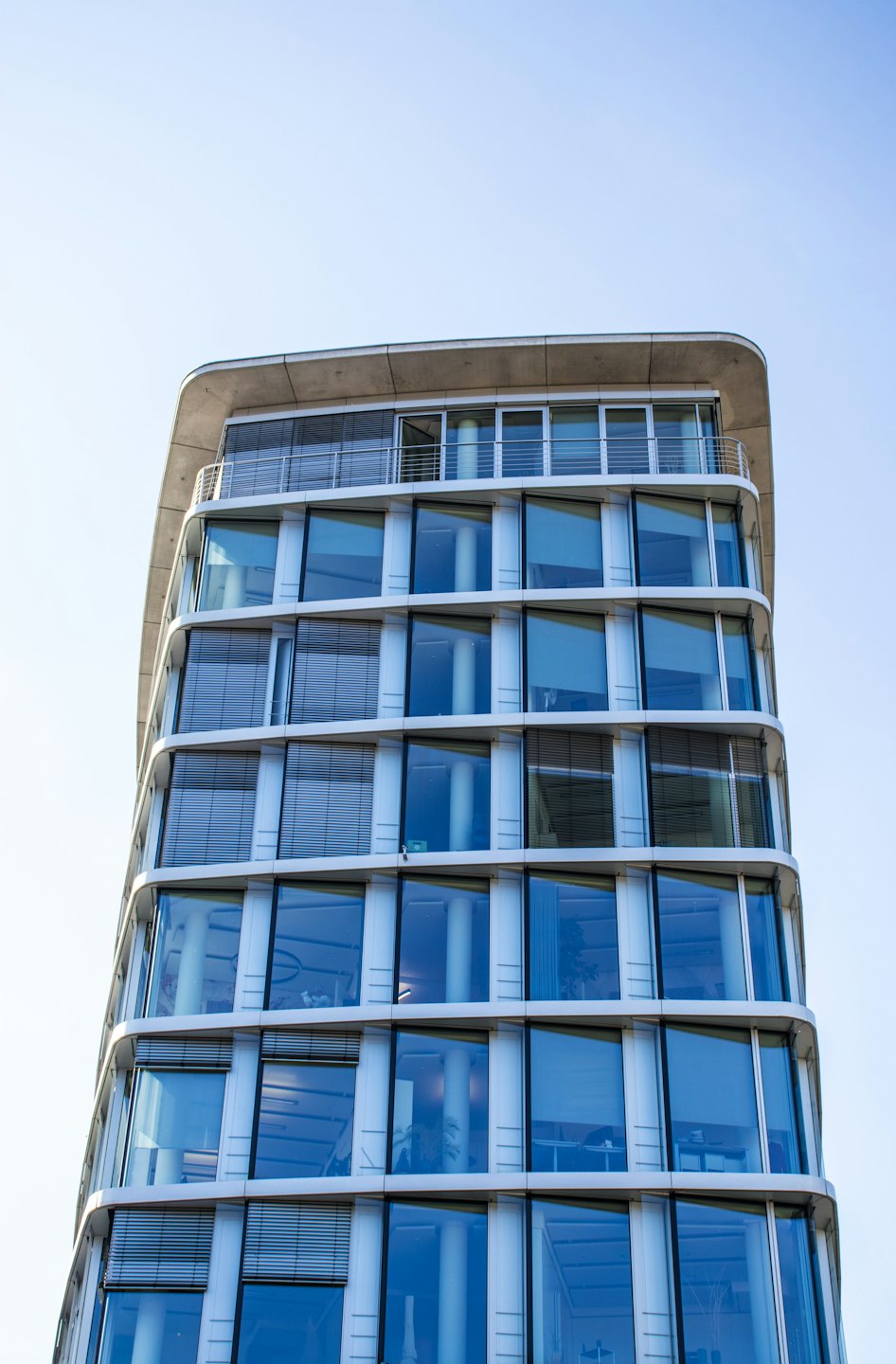 Modern office building with a curved glass facade.